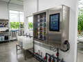 Commercial automated fertigation station mounted on a clean white wall in a modern greenhouse mechanical room